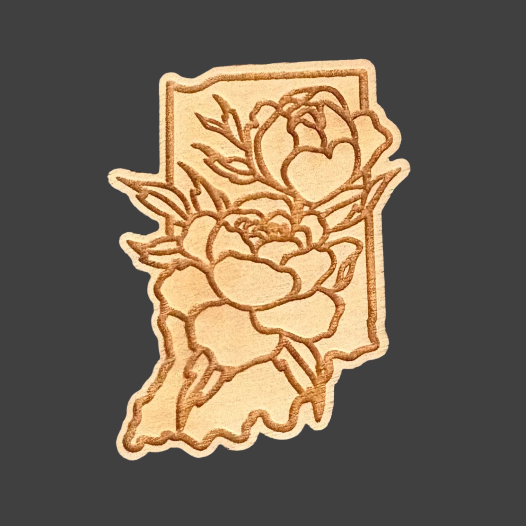 Wooden Indiana shaped magnet with peony design on a gray surface