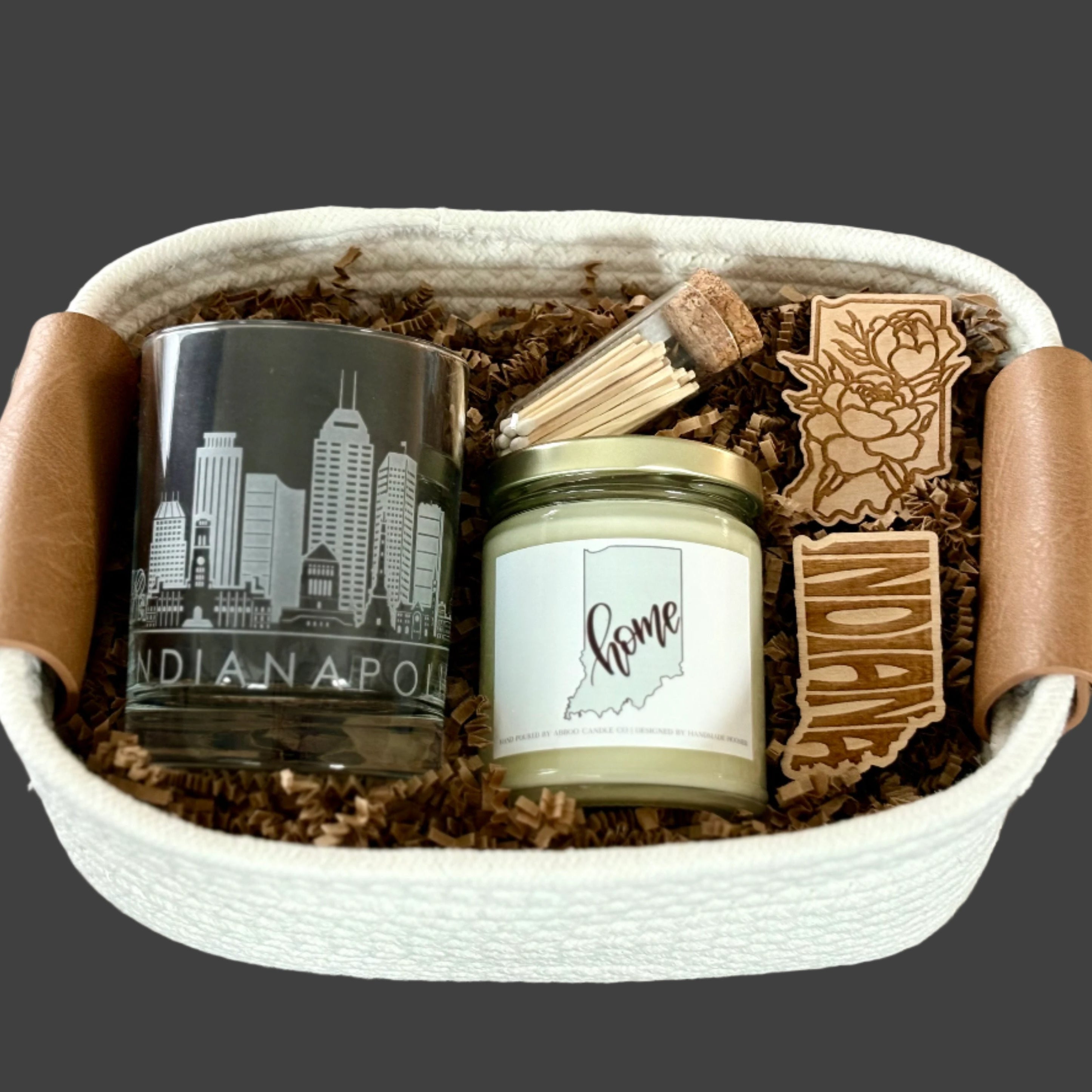 Gift basket with etched glass with Indianapolis skyline, Indy Home candle, and Indiana shaped wooden magnets, one with peony's on it