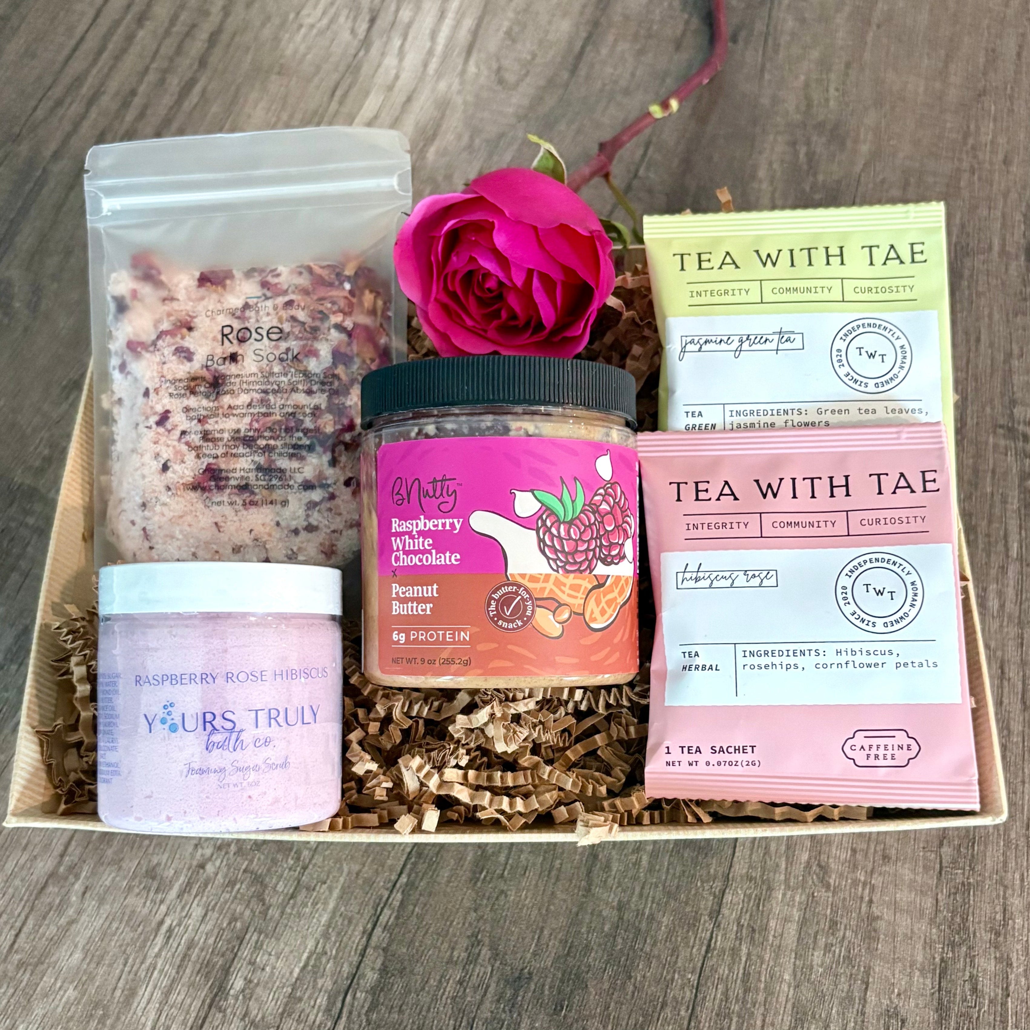 Gift set with skincare products and tea on a wooden surface