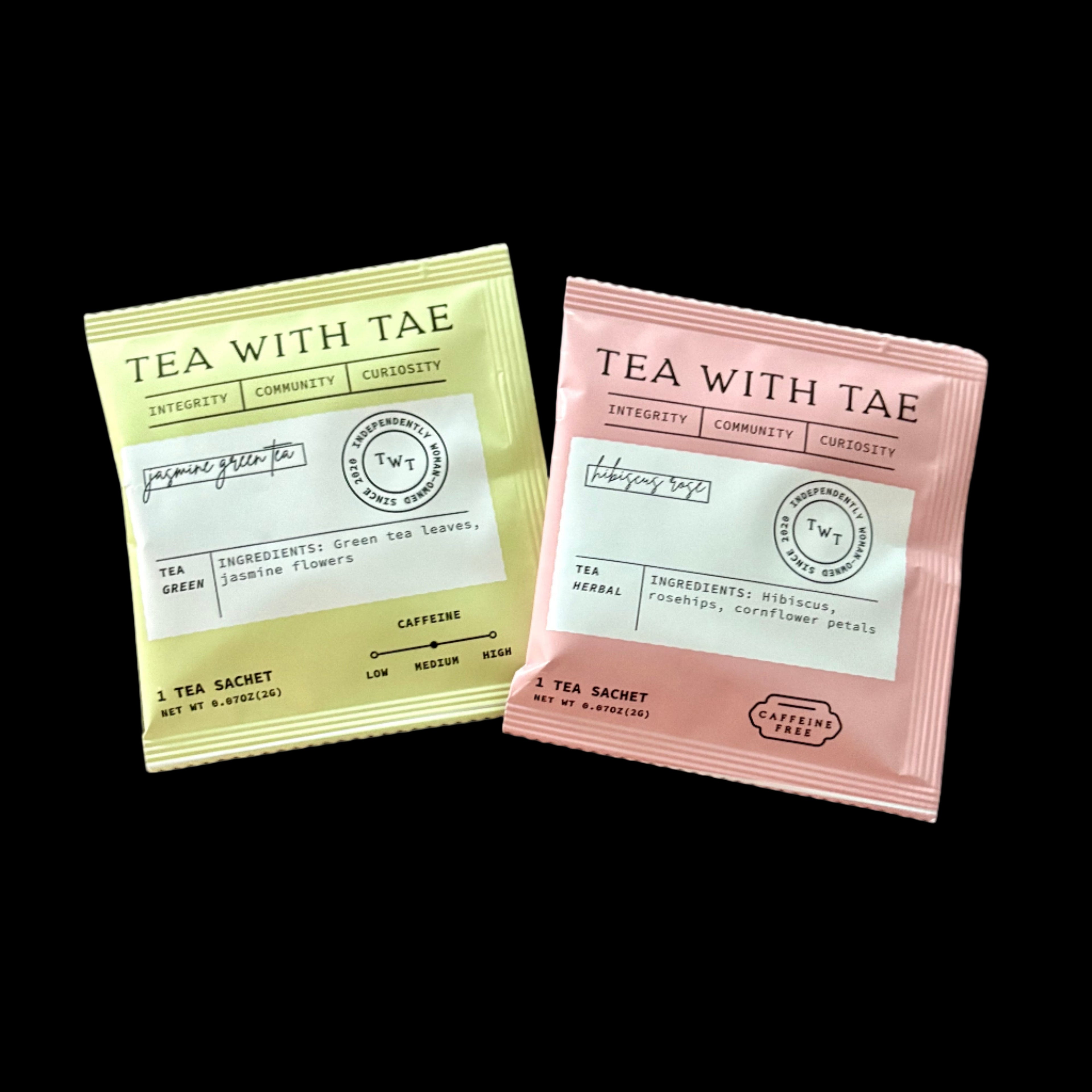 Two 'Tea with Tae' tea sachets on a wooden surface