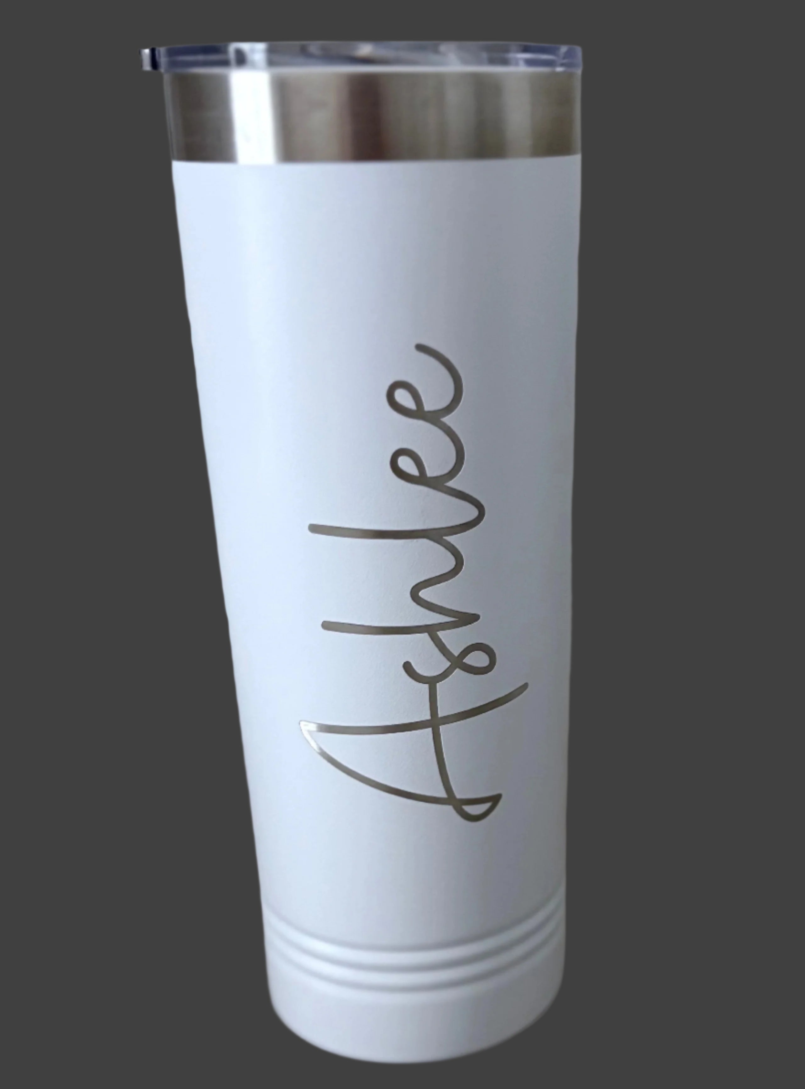 White tumbler with a name engraved on a gray background