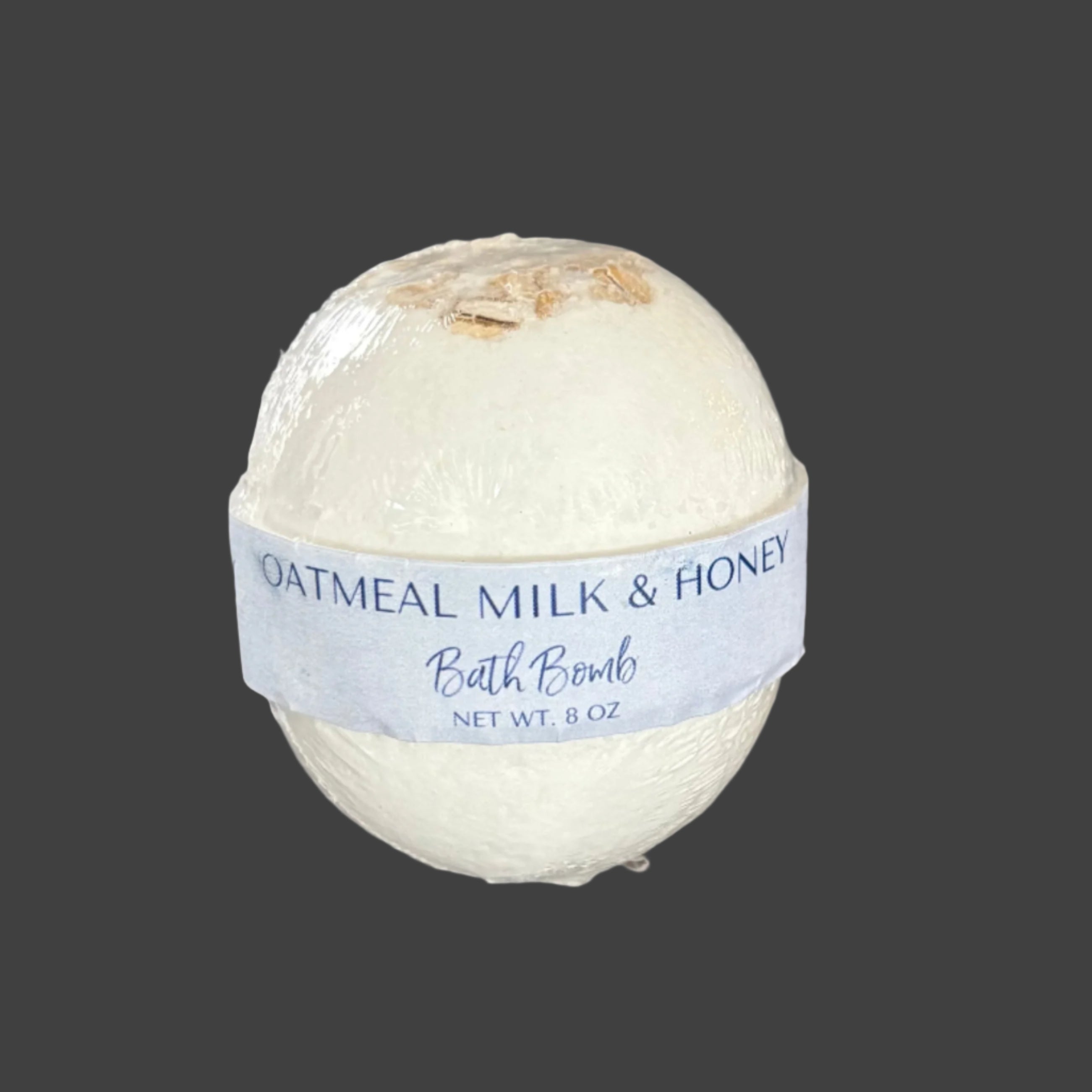 Oatmeal Milk & Honey bath bomb on a wooden surface 